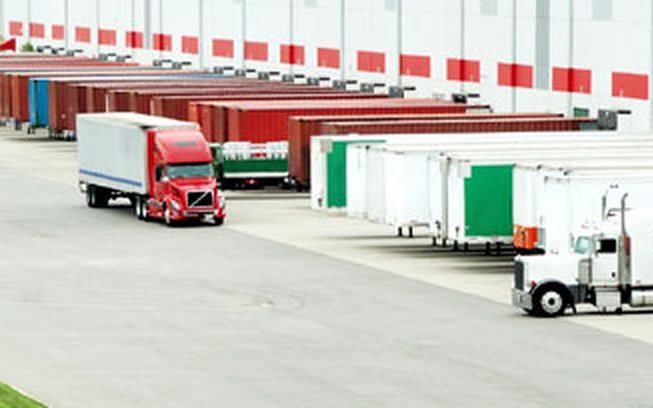 Tractor units and container trailers at an NADC Group dock